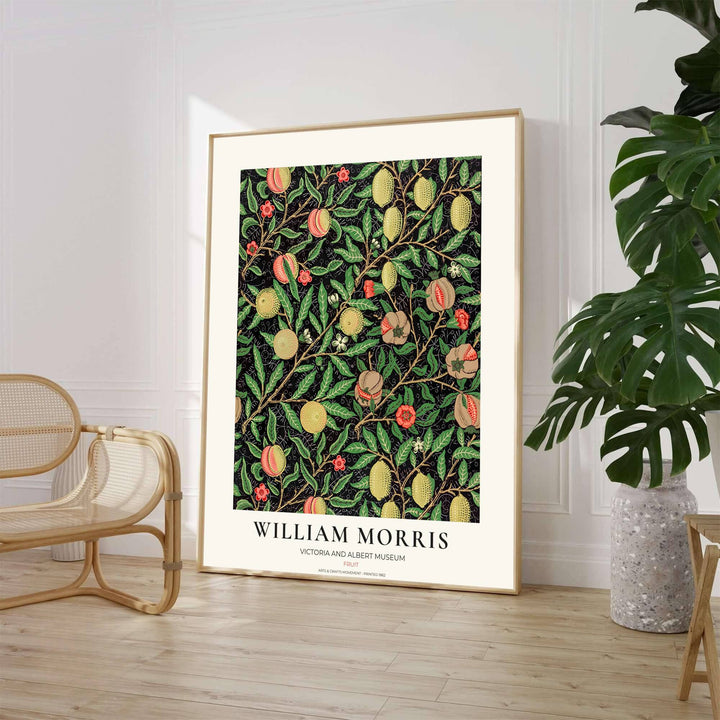Historic Arts and Crafts Movement wall art print displaying the William Morris Pomegranate design with rich green leaves and museum typography inside a cream border.
