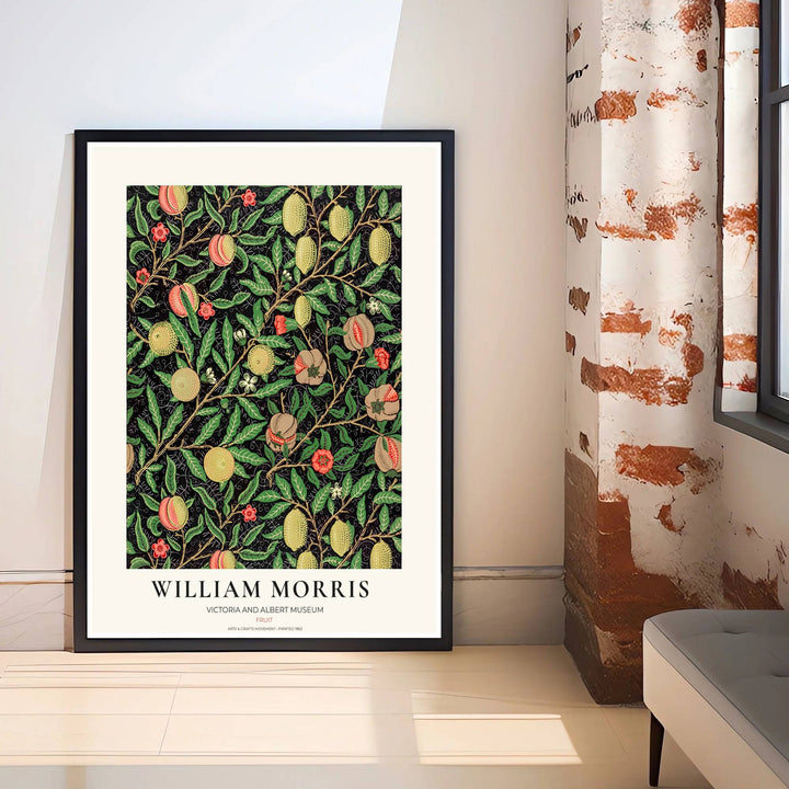 Detailed close-up of citrus fruits, hanging peaches, and red blossoms from the iconic dark black William Morris Fruit poster.