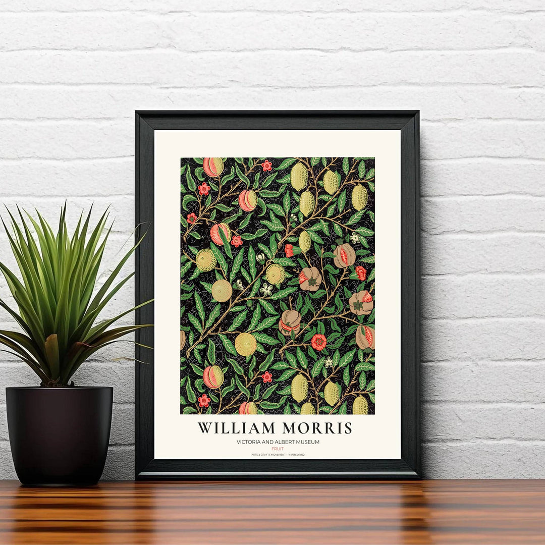 Symmetrical arrangement of hanging lemons, peaches, and pomegranates by William Morris rendered in warm yellow and red tones over a dark backdrop.