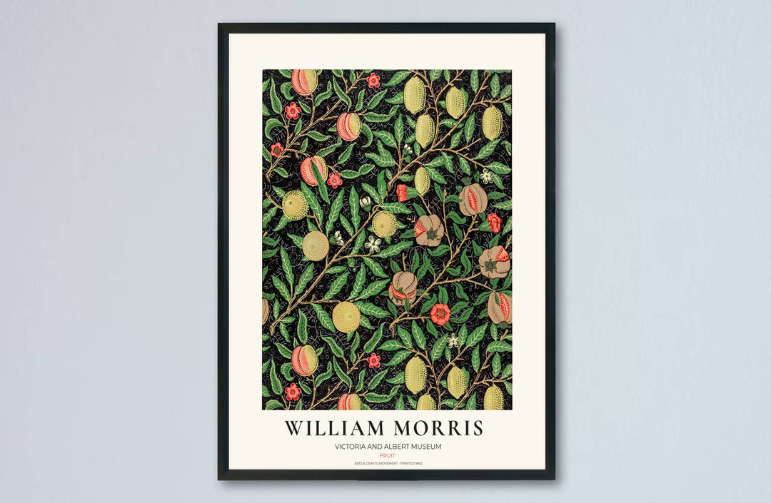 High-contrast dark botanical decor print featuring yellow citrus and pink peaches by William Morris, framed in a clean cream exhibition layout.