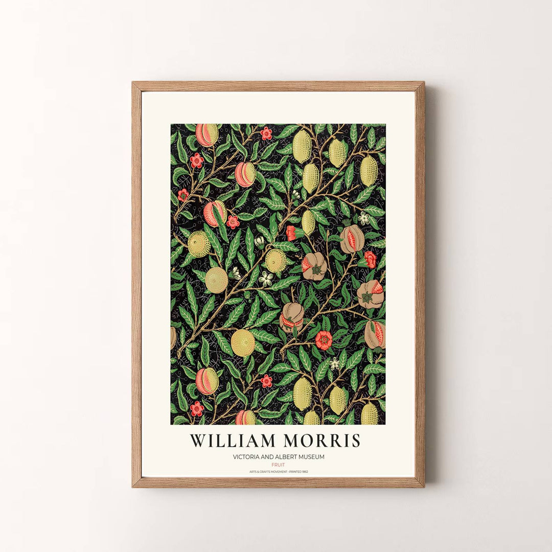 Vibrant botanical gallery wall piece featuring hanging William Morris lemons and peaches surrounded by dense green leaves over a dark black background.