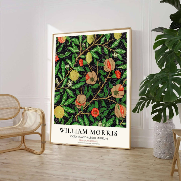 Historic Arts and Crafts Movement wall art print displaying the William Morris Pomegranate wallpaper layout with green foliage and museum typography inside a cream border.