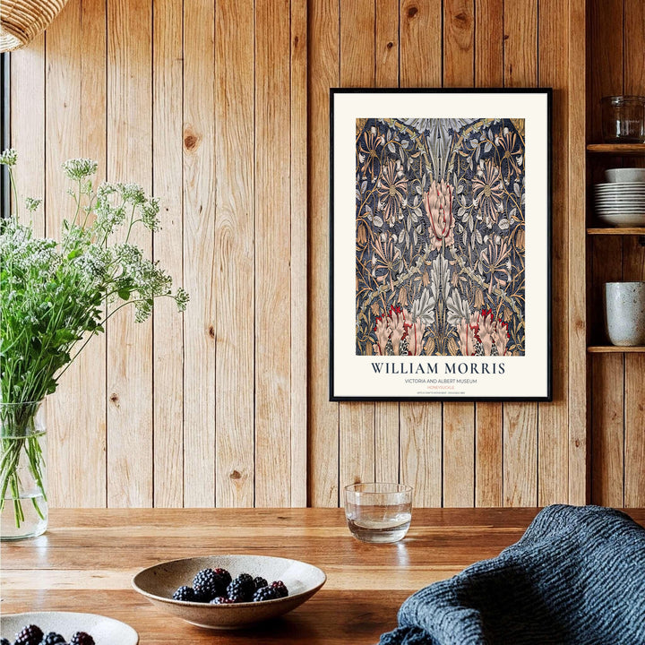 Winding golden honeysuckle vines and blushing pink blossoms by William Morris rendered over slate blue. Choose high quality framed, unframed, and canvas options available at MapYourDreams today.