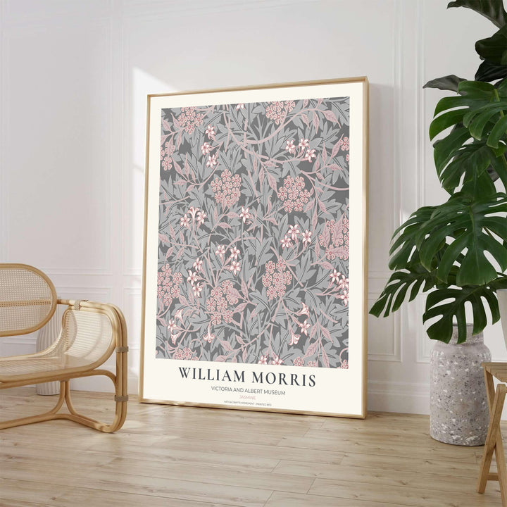 Star-shaped blush pink jasmine flowers and silver leaves over a charcoal background in a William Morris Jasmine print. MapYourDreams provides framed, unframed, and canvas options available for home interior decoration.