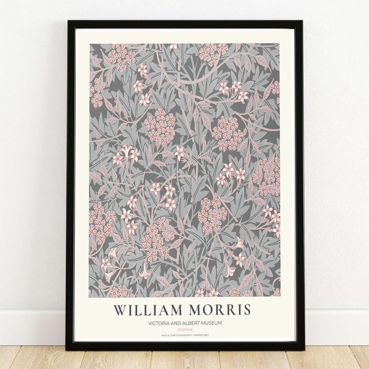 Winding grey stems and blush pink jasmine blossoms by William Morris rendered over charcoal grey. Choose high quality framed, unframed, and canvas options available at MapYourDreams today.