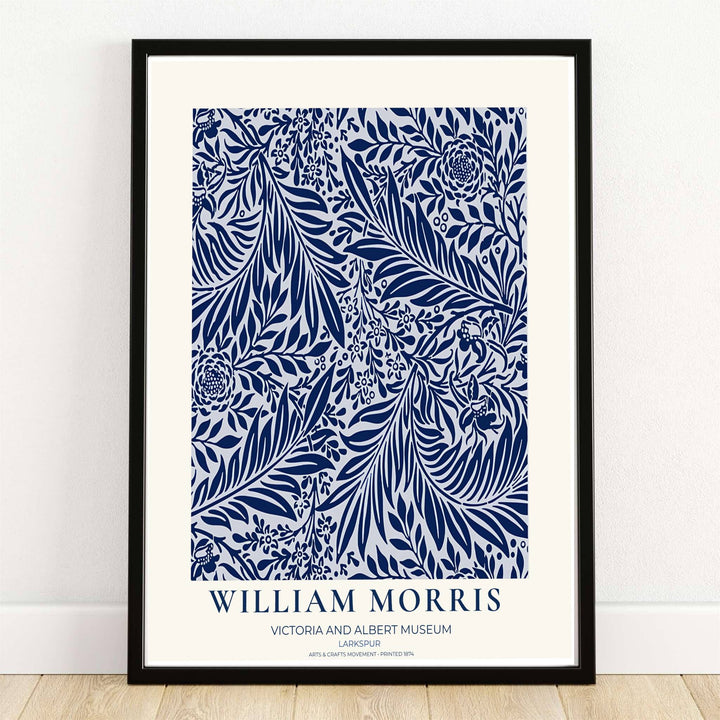 Deep navy blue larkspur blossoms and sweeping leaves over a white background in a William Morris Larkspur print. MapYourDreams provides framed, unframed, and canvas options available for home interior decoration.