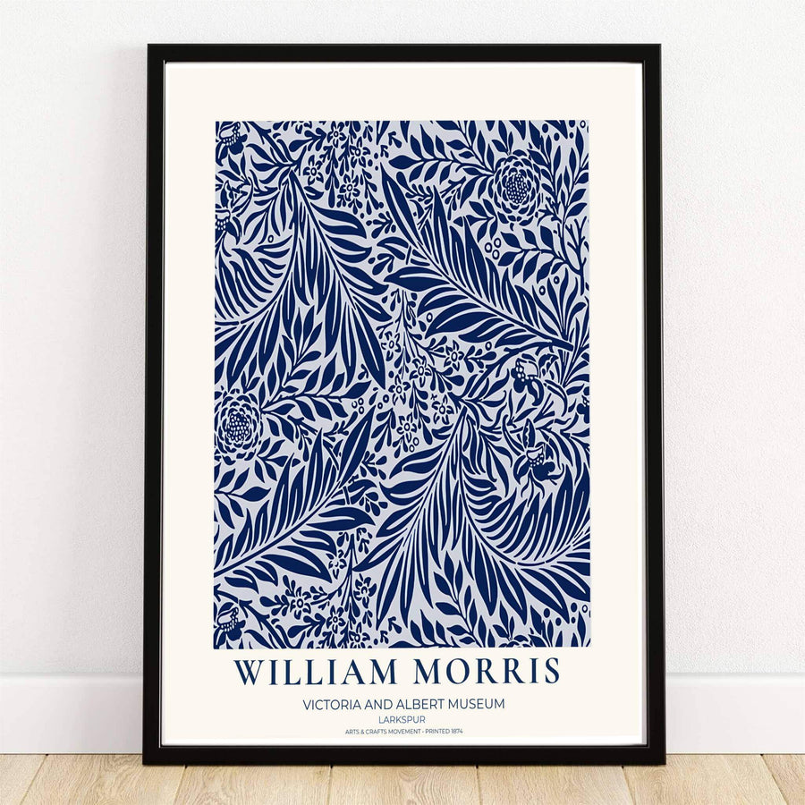 Deep navy blue larkspur blossoms and sweeping leaves over a white background in a William Morris Larkspur print. MapYourDreams provides framed, unframed, and canvas options available for home interior decoration.