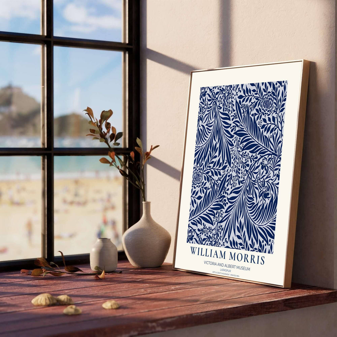 Close-up view of navy blue floral tendrils, willow leaves, and white background details from the William Morris Larkspur poster. MapYourDreams offers versatile framed, unframed, and canvas options available online.