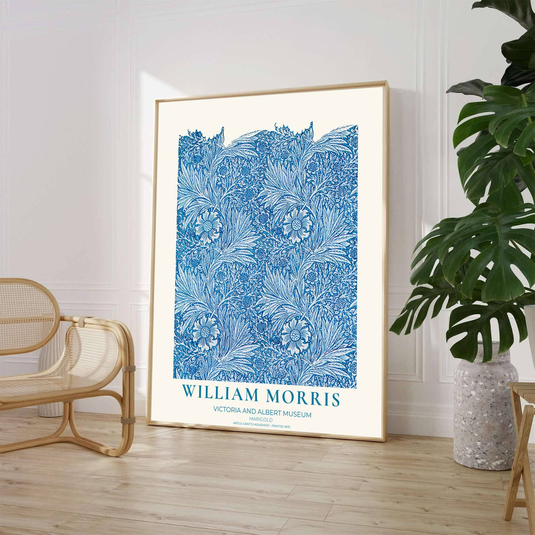 Close-up view of bright blue marigold petals, scrolling vines, and white background details from the William Morris Marigold poster. MapYourDreams offers versatile framed, unframed, and canvas options available online.