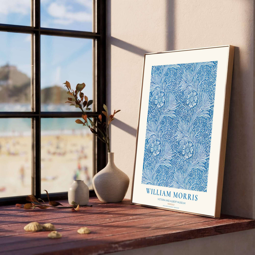 Close-up view of cobalt blue marigold petals, scrolling vines, and white background details from the William Morris Marigold poster. MapYourDreams offers versatile framed, unframed, and canvas options available online.