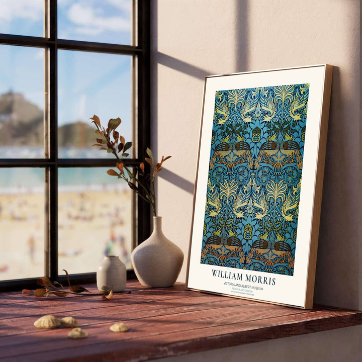 Close-up view of golden peacock feathers and blue acanthus leaves in a William Morris poster. Shop durable framed, unframed, and canvas options available online today at MapYourDreams for vintage wall styling.