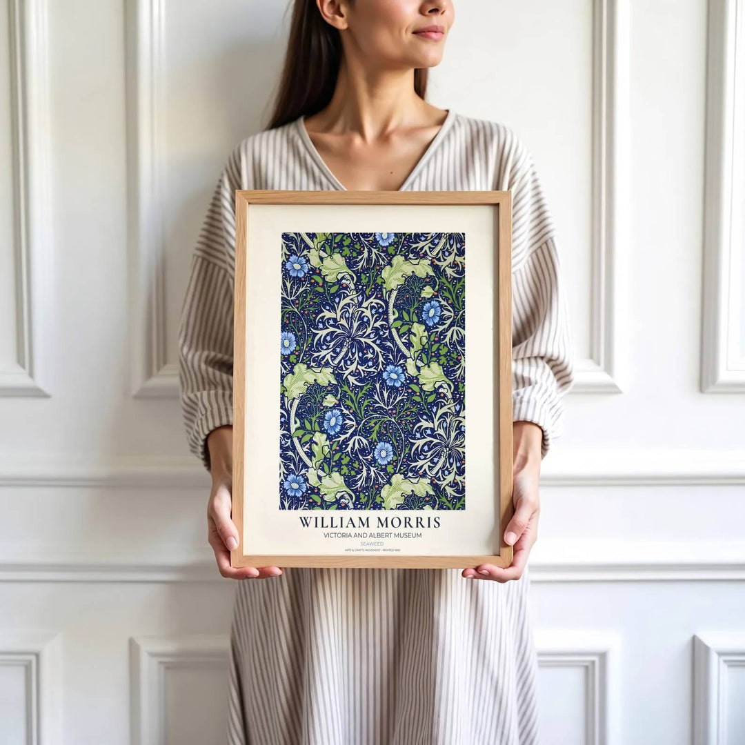 Blue periwinkle flowers and pale sage leaves highlight the central design of this William Morris Seaweed print. Find stunning framed, unframed, and canvas options available at MapYourDreams for a gallery wall display.