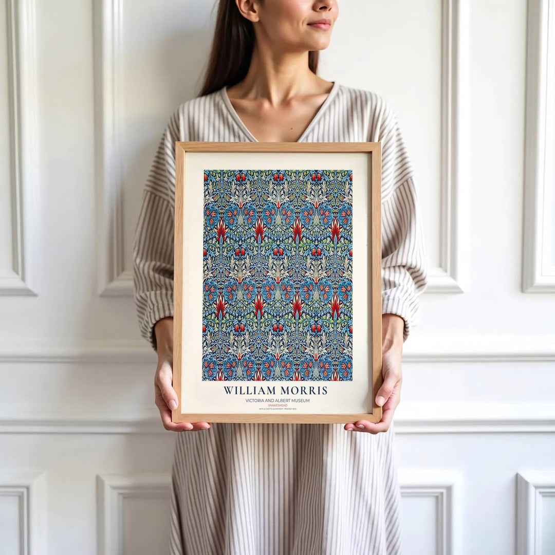 Flame red petals and dark blue leaves highlight the central design of this William Morris Snakeshead print. Find stunning framed, unframed, and canvas options available at MapYourDreams for a gallery wall display.