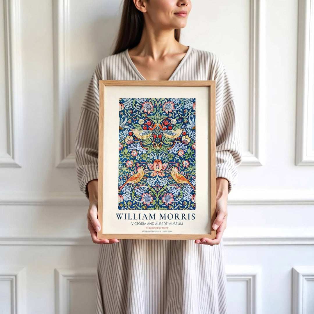 Bright red strawberries and blue birds highlight the central design of this William Morris Strawberry Thief print. Find stunning framed, unframed, and canvas options available at MapYourDreams for gallery walls.