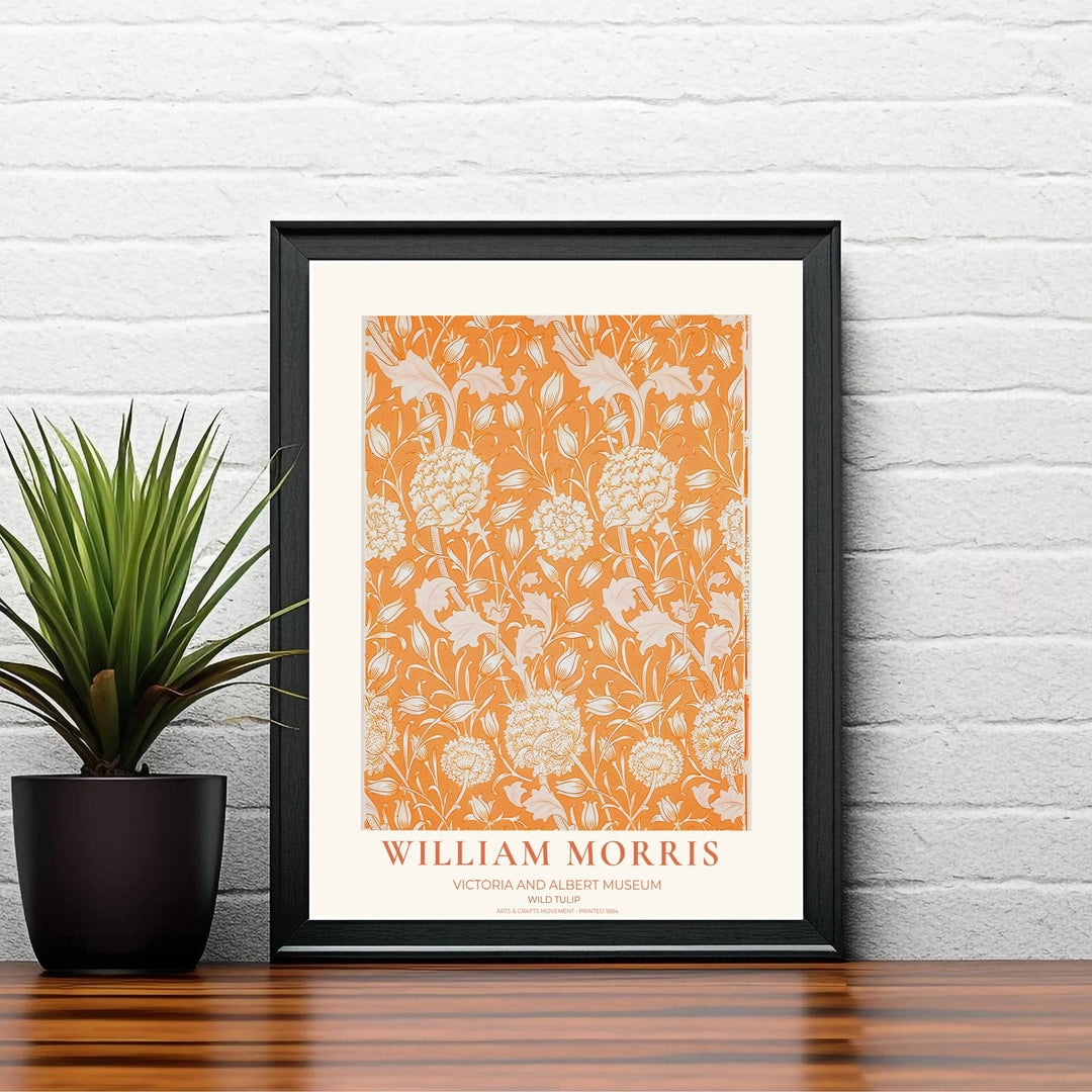 Terracotta orange William Morris Wild Tulip botanical print with cream exhibition border text. MapYourDreams offers versatile framed, unframed, and canvas print formats to enhance living room wall spaces.