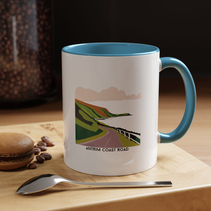 This Antrim Coast Road mug showcases the iconic Irish coastline with vivid scenic designs. Perfect for coffee or tea, it is made from dishwasher-safe ceramic and blends practicality with artistry, making it an excellent gift or keepsake for travelers.