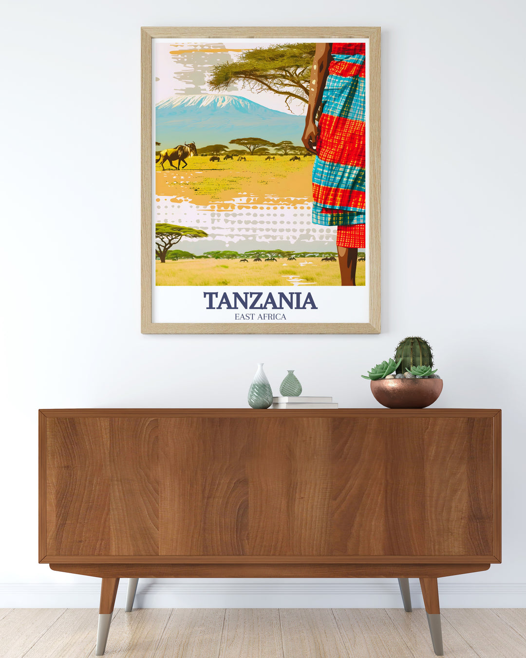 Our Mount Kilimanjaro travel print offers a stunning view of Africas highest peak, combined with the wildlife filled plains of Serengeti National Park. The artwork is perfect for those seeking to add a touch of Tanzanias iconic scenery to their home or office.