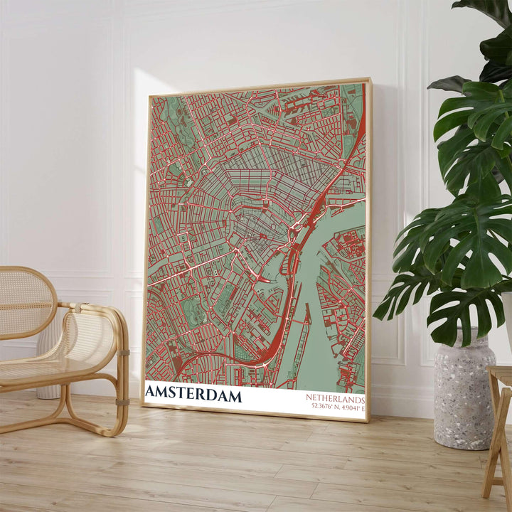 Earthy tone cartography print of an Amsterdam street map with red road networks across sage green terrain and teal waterways, offered by MapYourDreams where you can choose between an unframed archival paper poster, museum stretched canvas, or custom frame finishes for home office decor.
