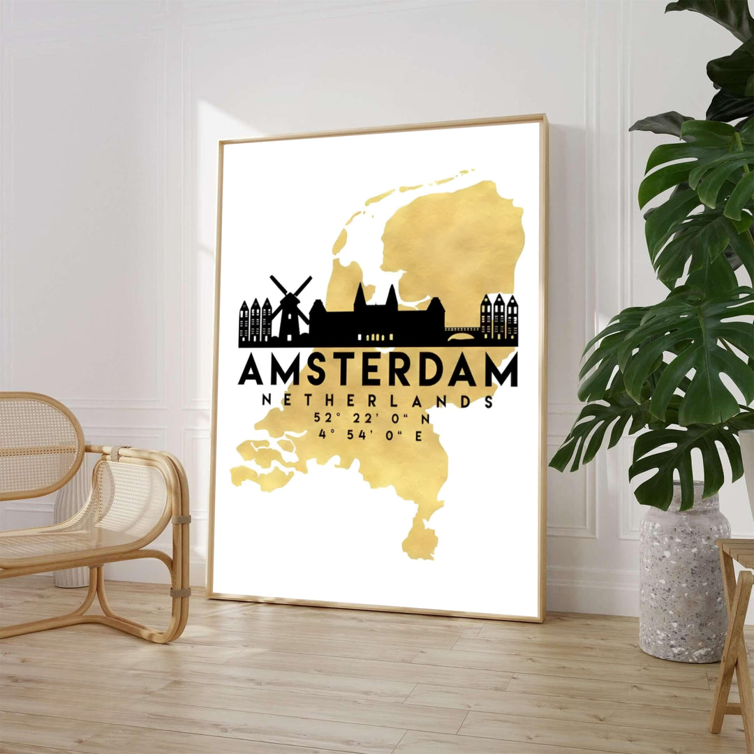 High-contrast luxury art print of the Netherlands map in metallic gold with an Amsterdam skyline silhouette including windmills and historic gables, offered by MapYourDreams where you can choose between an unframed paper poster, museum stretched canvas, or custom frame finishes for living rooms.