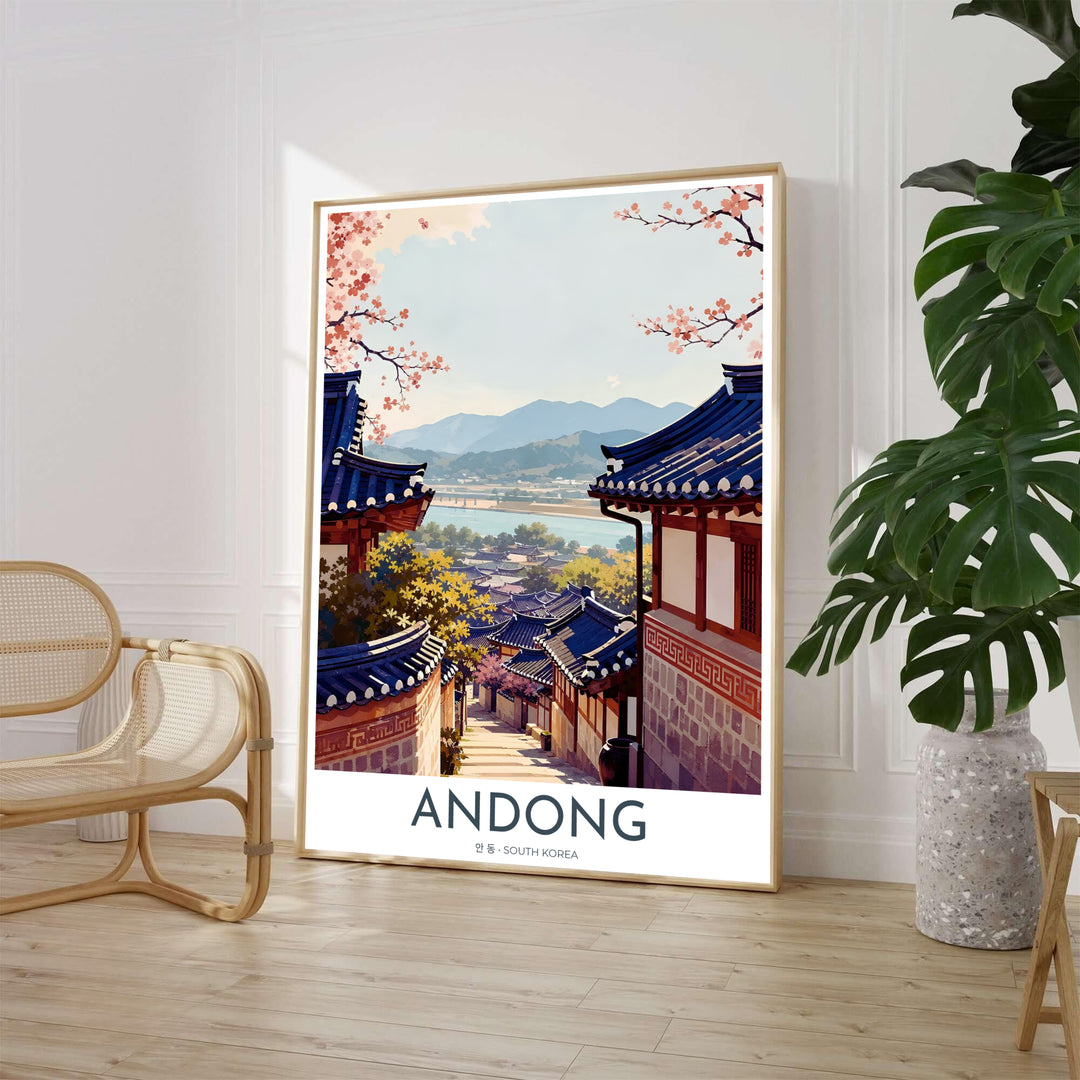 Scenic Asian landscape wall print illustrating the historic Hanok architecture of Hahoe Folk Village in Andong, South Korea, framed by blooming pink cherry blossom branches under a soft sky. Offered by MapYourDreams, this artwork is available in flexible options including unframed paper, custom wooden frames, and gallery canvas wraps.