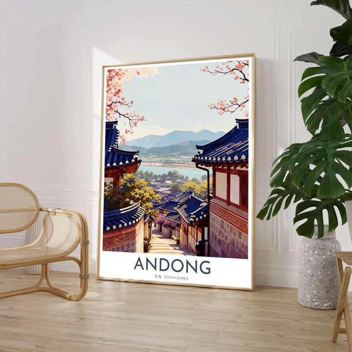 Scenic Asian landscape wall print illustrating the historic Hanok architecture of Hahoe Folk Village in Andong, South Korea, framed by blooming pink cherry blossom branches under a soft sky. Offered by MapYourDreams, this artwork is available in flexible options including unframed paper, custom wooden frames, and gallery canvas wraps.
