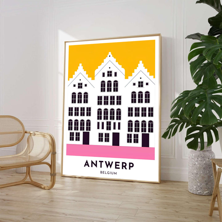 A minimalist architectural poster featuring three white Flemish Renaissance building facades in Antwerp, Belgium, set against a sunny yellow background with pink ground accents. Available from MapYourDreams in various choices like standalone unframed paper, tailored wooden frames, and gallery-wrapped canvas options.