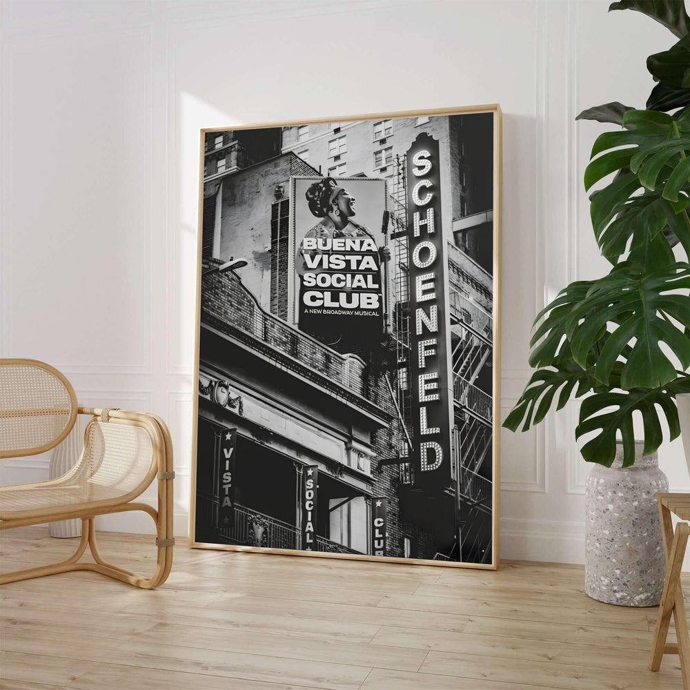 Black and white Theatre District print featuring the glowing marquee sign and promotional billboard at the Gerald Schoenfeld Theatre in Manhattan NYC, available from MapYourDreams where shoppers can select unframed fine art posters, gallery wrapped canvas decor, and custom frame options for home lounges.
