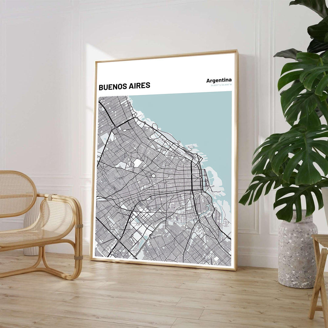 Minimalist city grid wall decor of Buenos Aires featuring charcoal road networks and light blue coastal water accents. Available through MapYourDreams, customers can select from fine art paper, handcrafted timber frames, or stretched canvas options.