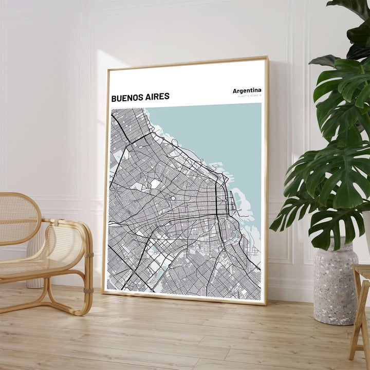 Minimalist city grid wall decor of Buenos Aires featuring charcoal road networks and light blue coastal water accents. Available through MapYourDreams, customers can select from fine art paper, handcrafted timber frames, or stretched canvas options.