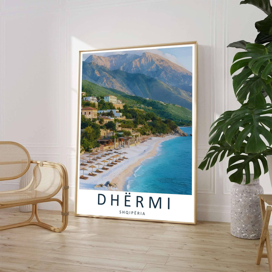 A high-angle landscape photo captures thatched umbrellas along the Albanian Riviera coast in Dhërmi, backed by lush green hillsides and coastal stone villas. Select from flexible display choices like unframed paper stock, custom frames in various wood finishes, or gallery canvas wraps.