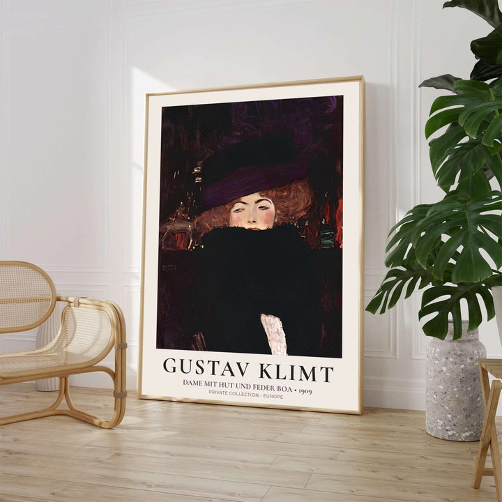 Gustav Klimt Dame Mit Hut Und Federboa 1909 exhibition poster displaying an elegant lady with a feather boa from a Private Collection in Europe. MapYourDreams provides custom framed wall art, unframed paper poster prints, and gallery stretched canvas wall decor options to elevate moody living room interiors.