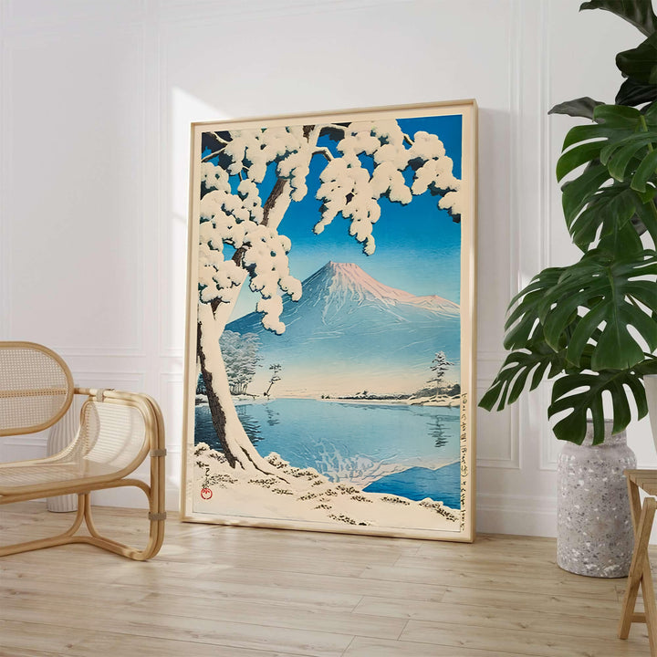 Traditional Asian winter mountain print Lake Kawaguchi by artist Kawase Hasui displaying snow-draped pine branches along the shore at Lake Kawaguchi. MapYourDreams supplies framed, unframed, and canvas poster options for wall decor.