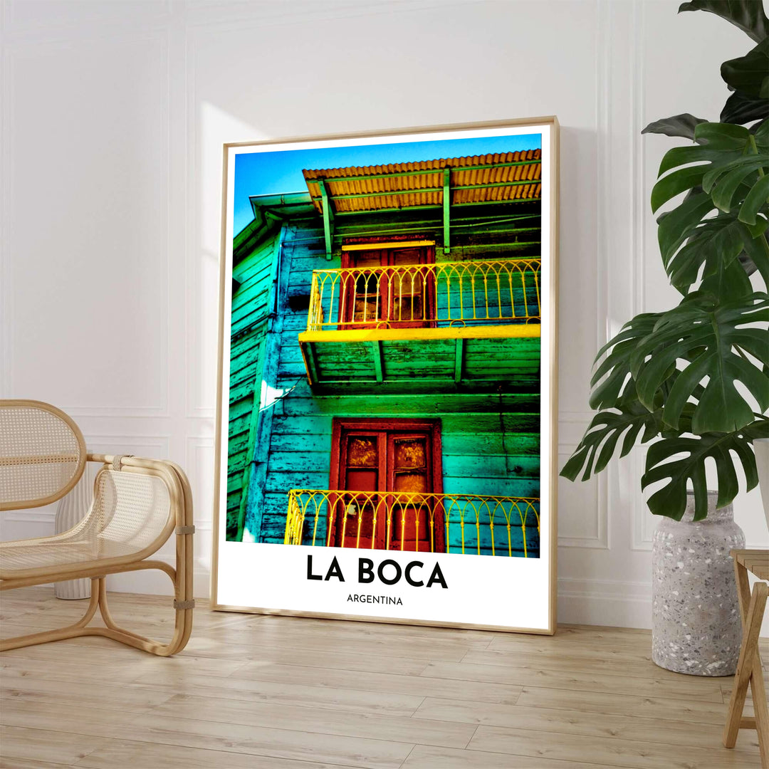 Vibrant street architecture wall decor featuring a low-angle photograph of a rustic turquoise and yellow balcony in La Boca, Argentina. Available through MapYourDreams, customers can select from fine art paper, handcrafted timber frames, or stretched canvas options.
