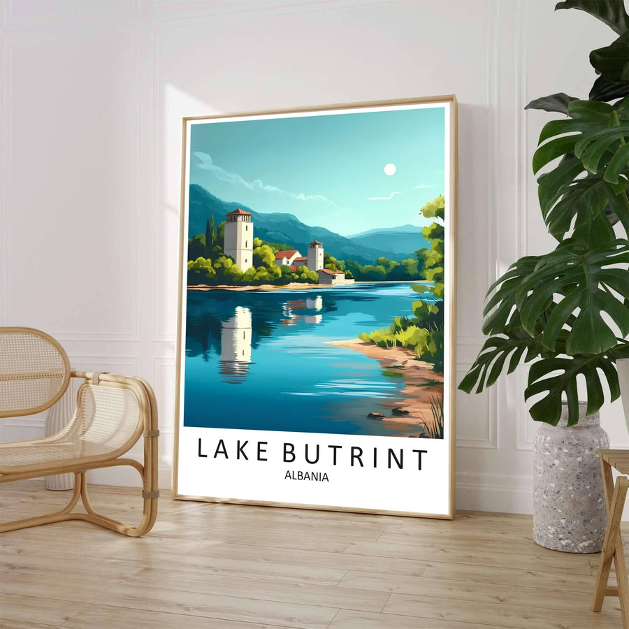 A clean mid-century travel illustration captures the serene shores of Lake Butrint with ancient fortifications and lush green hills under a teal sky. Customers can select from unframed archival paper stock, custom wood frames, or gallery canvas wraps to suit their home decor style.