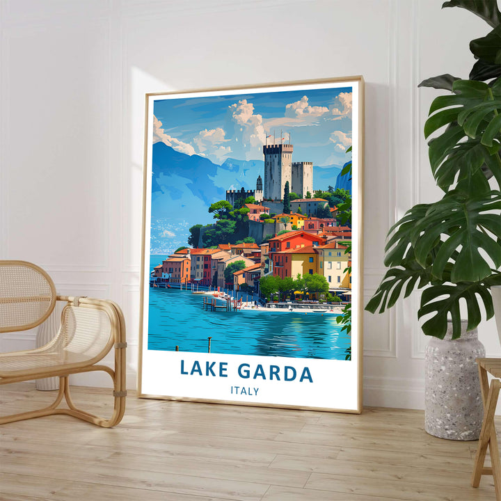 A vibrant Lake Garda travel poster showing Malcesine Castle on a rocky hill in Italy, surrounded by colorful red-roofed buildings and turquoise water under a blue sky with fluffy clouds; available as a high-quality framed print, standalone unframed poster, or gallery-wrapped canvas print.