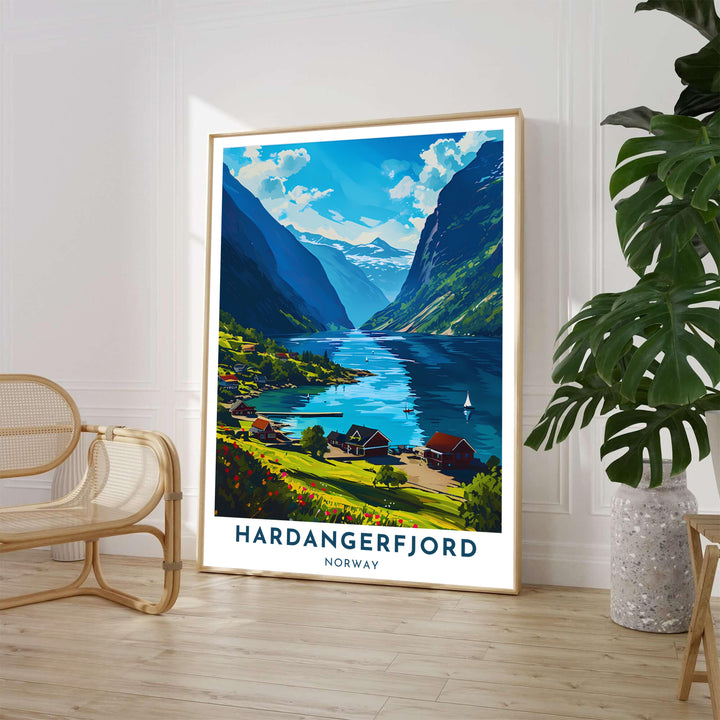 Scenic Scandinavian summer poster depicting a peaceful fjord village along Hardangerfjord Norway with blooming red flowers and calm blue waters. Perfect for home decor, this artwork is offered in multiple options including custom wood framed prints, gallery wrapped canvas, and unframed paper.