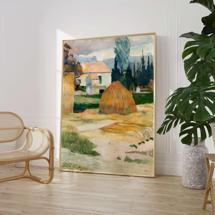 Paul Gauguin Landscape Near Arles 1888 fine art poster featuring golden haystacks and a traditional farmhouse in Arles, Provence, France. MapYourDreams provides custom framed wall art, unframed paper prints, and gallery stretched canvas wall decor options to elevate rustic living room interiors.
