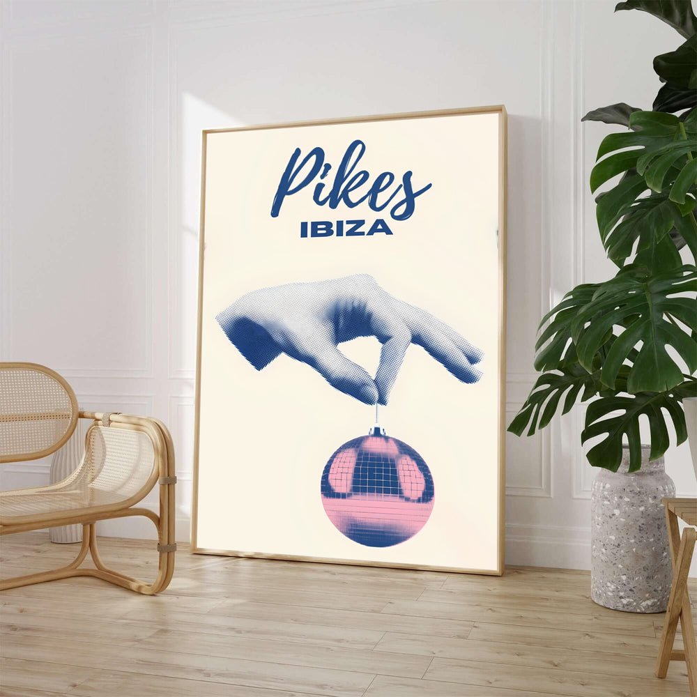 Surreal Pikes Ibiza nightclub art poster displaying minimalist navy script typography and pop-art disco ball graphics, available from MapYourDreams as an unframed paper print, ready-to-hang gallery canvas wall art, or custom framed decor in black, white, and natural wood frame finishes.