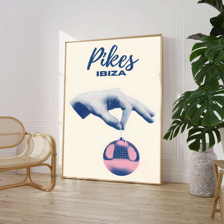 Surreal Pikes Ibiza nightclub art poster displaying minimalist navy script typography and pop-art disco ball graphics, available from MapYourDreams as an unframed paper print, ready-to-hang gallery canvas wall art, or custom framed decor in black, white, and natural wood frame finishes.