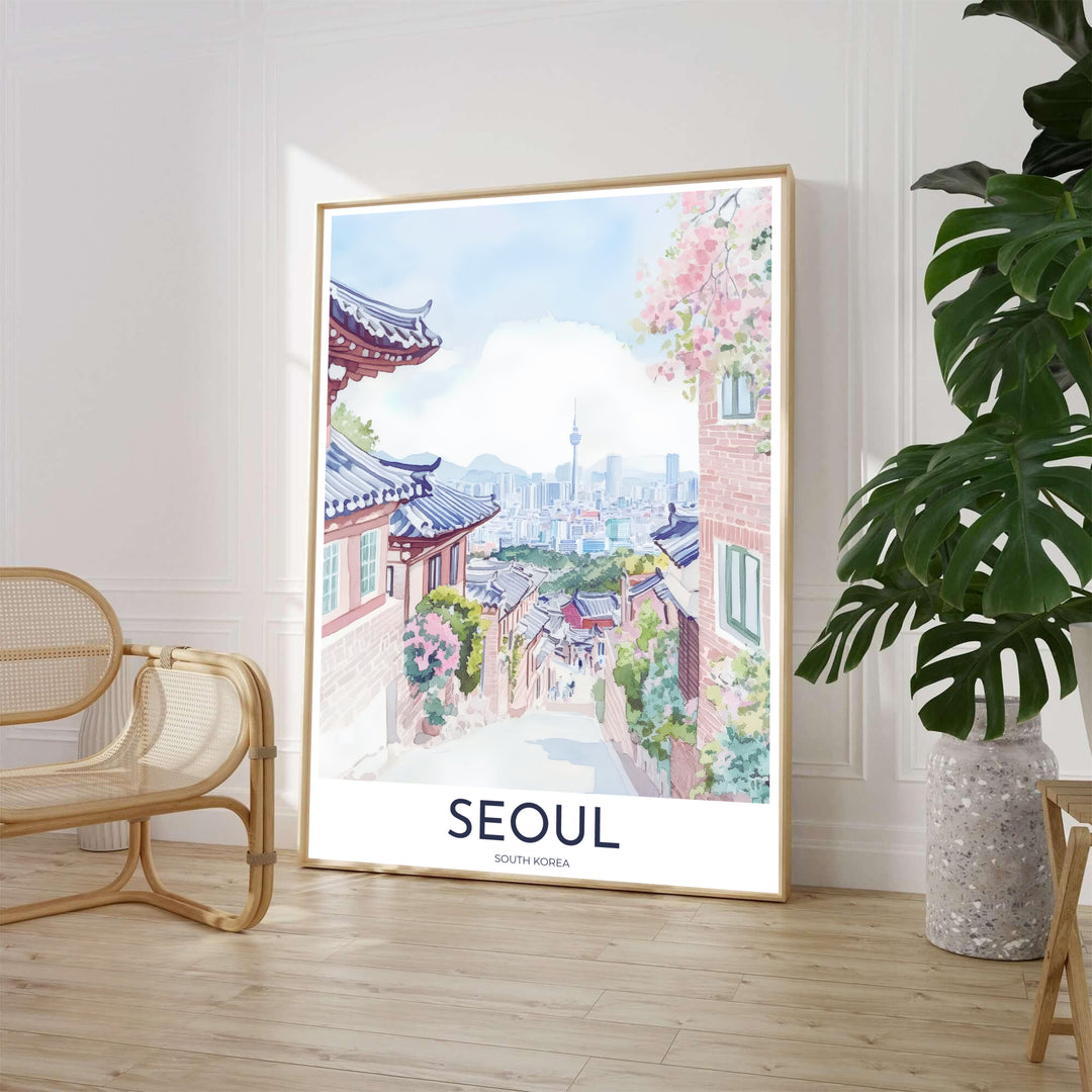 Gentle pastel watercolor poster showcasing an elevated alley in Seoul, South Korea, where traditional Hanok houses with cobalt tiled roofs descend toward modern city high-rises and N Seoul Tower. Offered by MapYourDreams, this artwork is available in flexible options including unframed paper, custom wooden frames, and gallery canvas wraps.