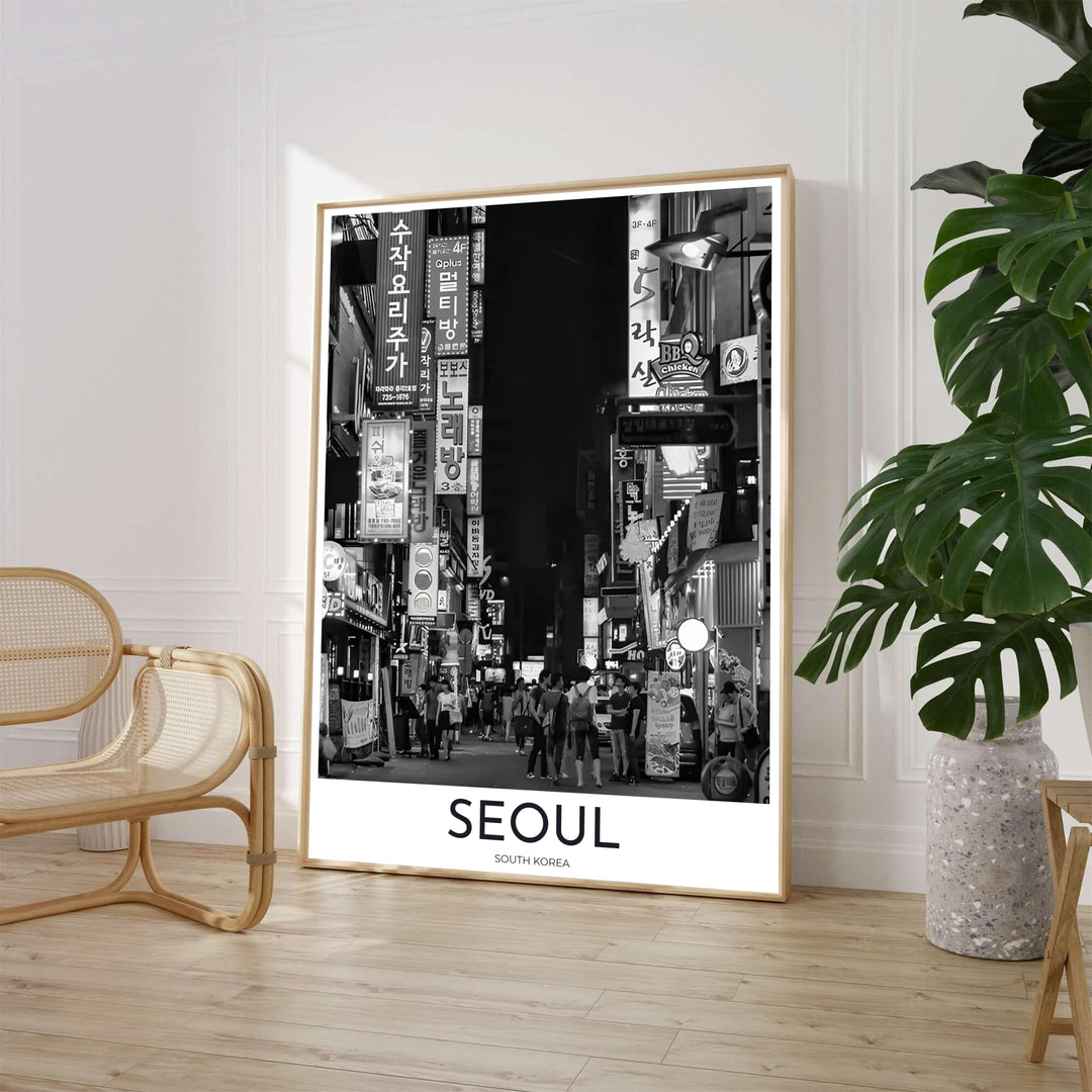 Dramatic black and white night alley travel poster featuring pedestrians and Korean storefront signs in Seoul South Korea, presented by MapYourDreams with versatile choices such as unframed archival paper, sleek picture frames, and stretched canvas options designed to complement modern interiors.