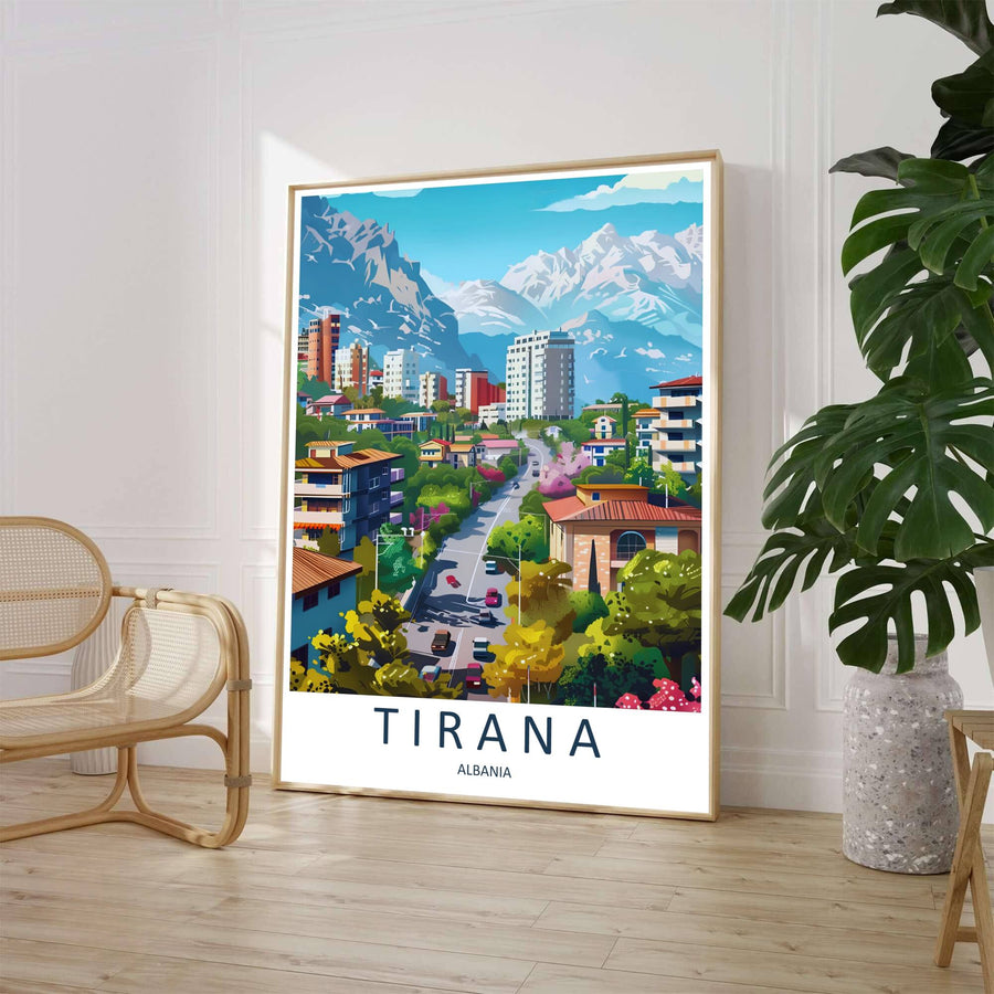 A clean mid-century travel illustration portrays a sunny Tirana streetscape framed by lush foliage and red-roofed buildings beneath majestic mountain ridges. Customers can select from unframed archival paper stock, custom wood frames, or gallery canvas wraps to suit their home decor style.