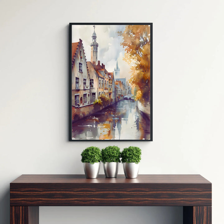 An impressionistic watercolor poster showcasing golden foliage along historic canal facades in Bruges, Belgium, beneath a soft cloudy sky. Available from MapYourDreams in versatile choices including unframed archival poster paper, custom frames, and stretched gallery canvas formats.