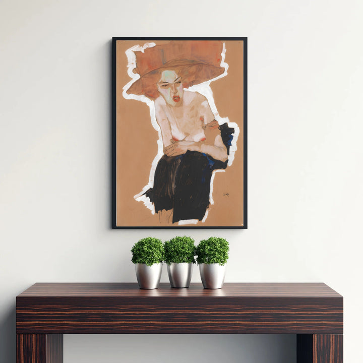 Early 20th century avant-garde graphic print of Egon Schiele Seated Woman With Hat 1910 produced in Vienna Austria featuring expressive posture. Discover custom framed prints, unframed poster options, and stretched canvas wall decor at MapYourDreams for sophisticated home art displays.