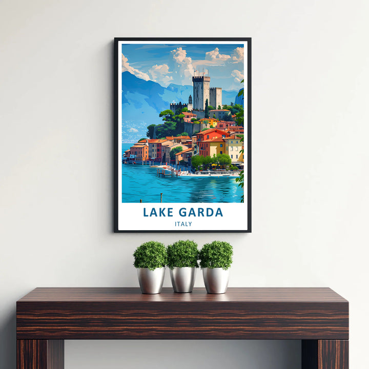 A serene travel poster of Lake Garda in Northern Italy showcasing the scenic village of Malcesine nestled beneath soaring mountains and blue skies; bring this Mediterranean view into your space with options including framed wall art, unframed paper posters, and canvas prints.