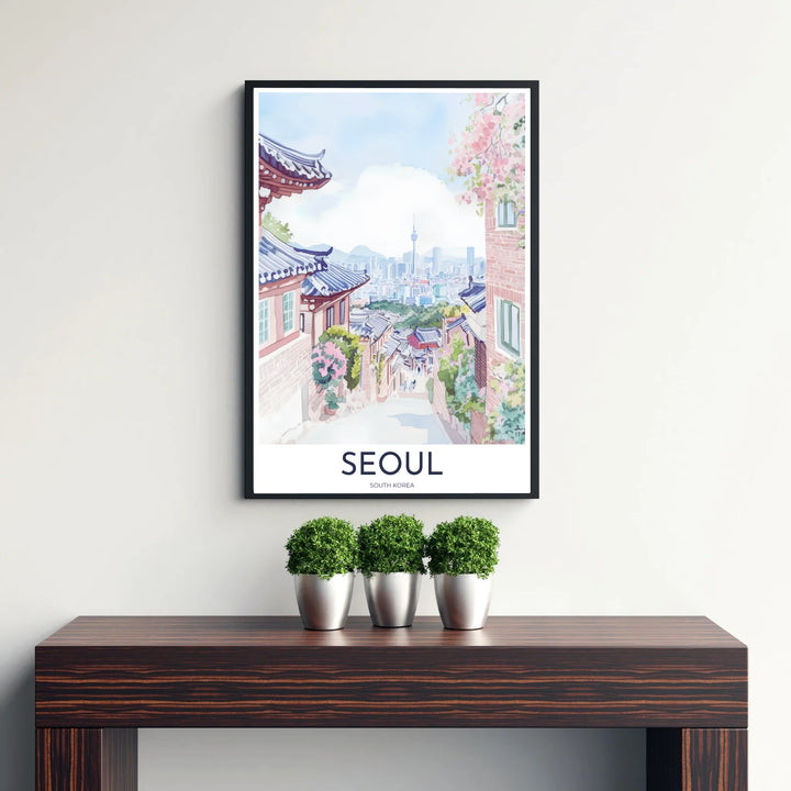 Picturesque Korean watercolor print showing Bukchon Hanok Village in Seoul, South Korea, bathed in gentle pastel light with lush pink floral clusters framing the distant mountain and city silhouette. Offered by MapYourDreams, this artwork is available in flexible options including unframed paper, custom wooden frames, and gallery canvas wraps.
