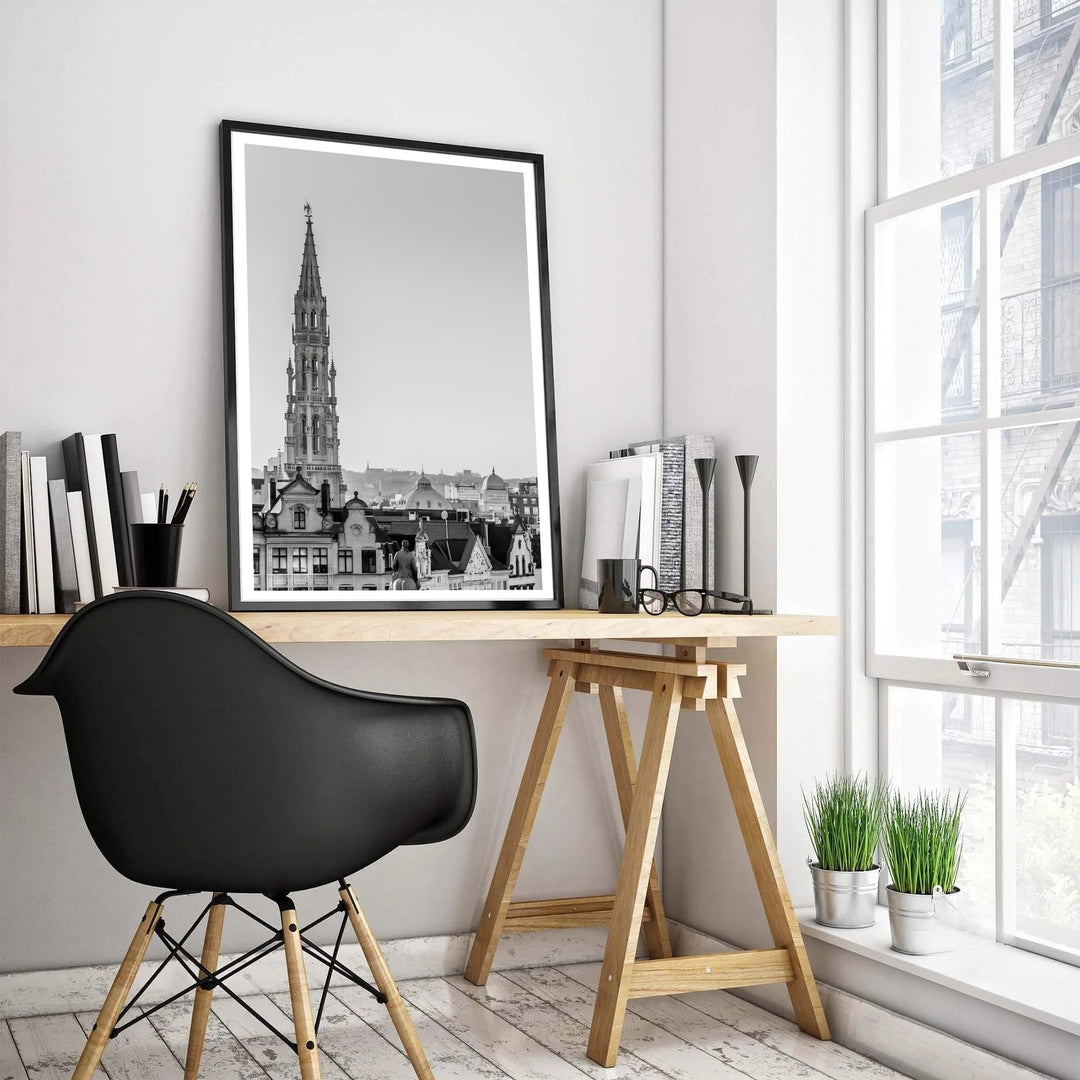 Vertical monochrome travel poster depicting the historic skyline and Gothic spire of Brussels, Belgium, against a clean sky. Offered by MapYourDreams, this artwork is available in flexible options including unframed paper, custom wooden frames, and gallery canvas wraps.