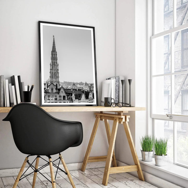 Vertical monochrome travel poster depicting the historic skyline and Gothic spire of Brussels, Belgium, against a clean sky. Offered by MapYourDreams, this artwork is available in flexible options including unframed paper, custom wooden frames, and gallery canvas wraps.