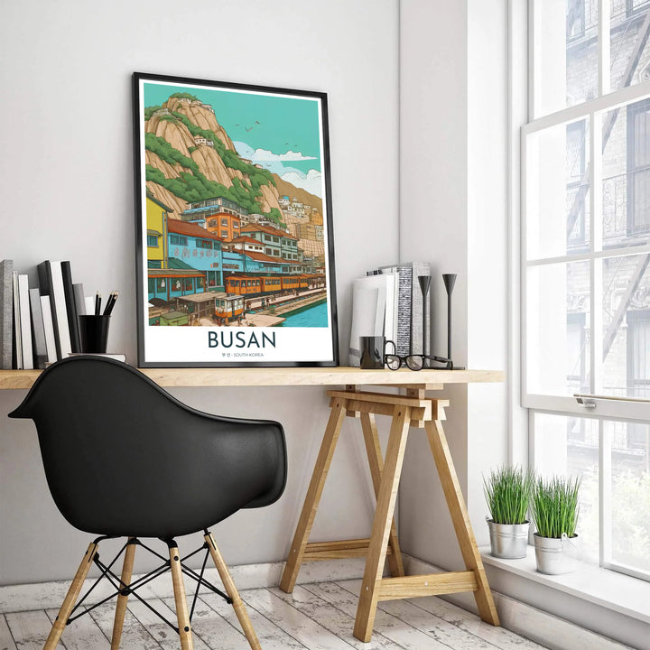 Minimalist vector illustration of Busan, South Korea, featuring the famous coastal sightseeing train line running parallel to vibrant waterfront houses and blue ocean waters. Offered by MapYourDreams, this artwork is available in flexible options including unframed paper, custom wooden frames, and gallery canvas wraps.