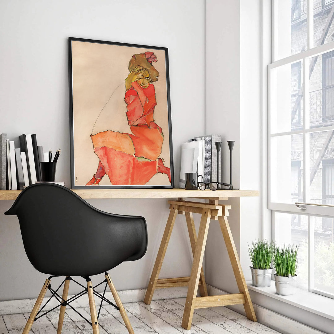 Earthy cream background figure wall poster of Egon Schiele Kneeling Female In Orange Red Dress 1910 from Leopold Museum Vienna highlighting sharp contour hatchings. MapYourDreams supplies custom framed paper prints, unframed wall posters, and gallery stretched canvas art for living rooms and bedrooms.